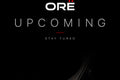 Dark background with 'ORE' logo and 'UPCOMING STAY TUNED' text