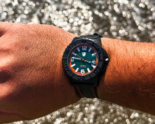 Wrist wearing a watch with a blurred water background